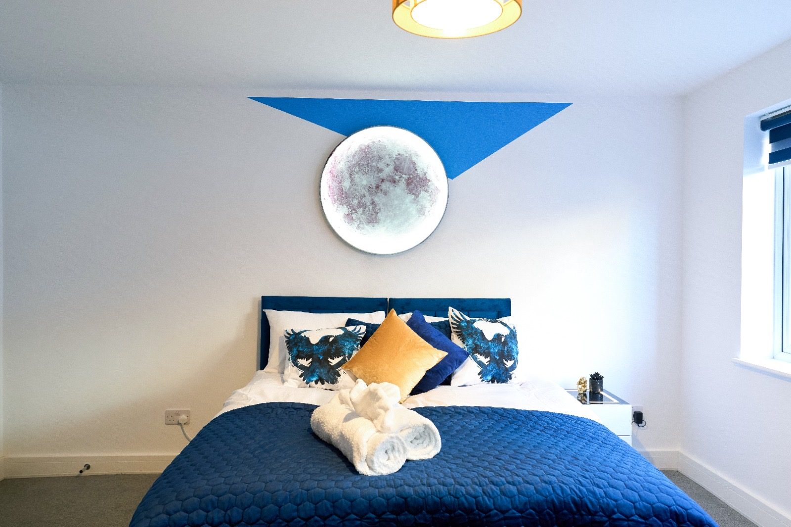 Double bed beneath a circular moon light