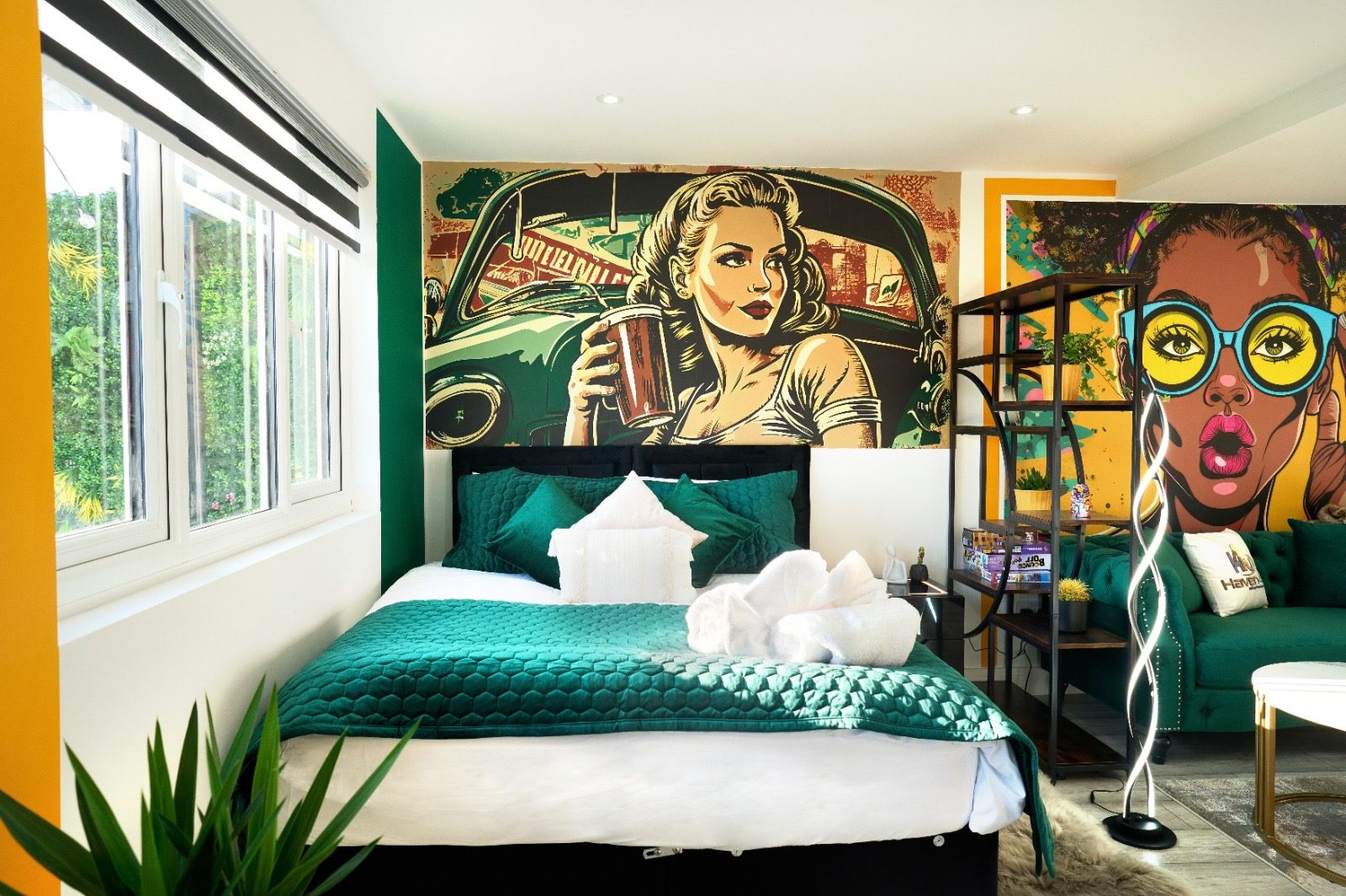 Double bed with emerald bedding and retro pin-up mural