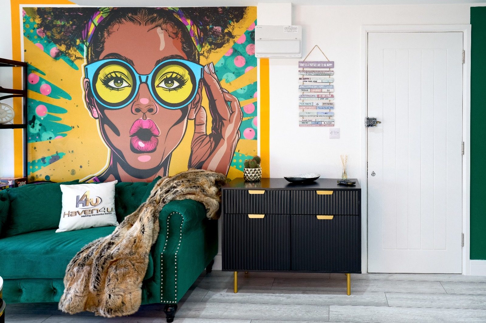 The Pop Art House, green velvet lounge beneath a pop-art mural